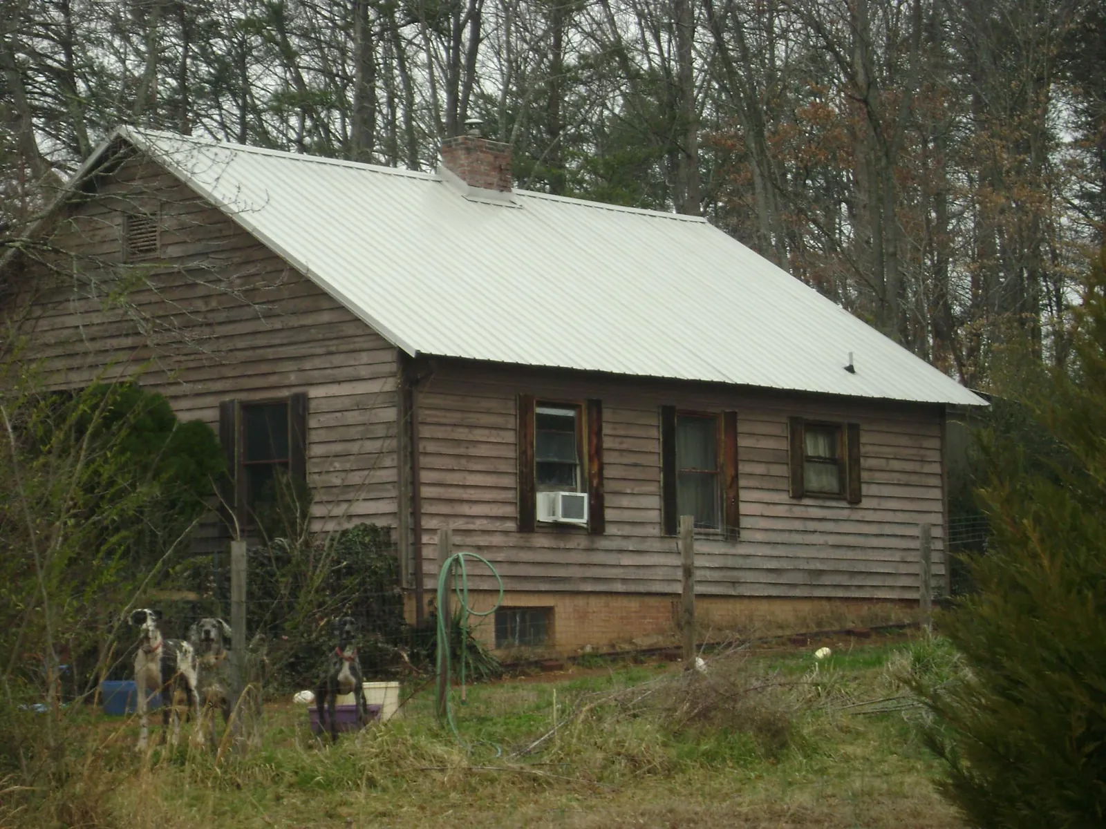 White metal roof on an old wood sided farmhouse, from a Metal Roof Installation job in Northport